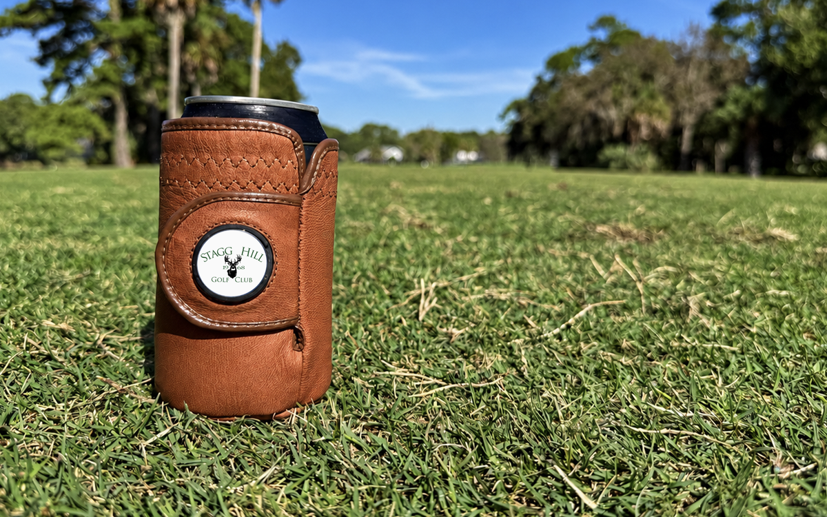 Brown Gloozie golf coozie with a custom Stagg Hills Golf Club ball marker on a golf course