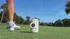 Gloozie golf coozies in white, green, and brown shown on the golf course with golf balls, clubs, and golfers