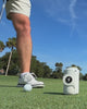 Gloozie golf coozies in white, green, and brown shown on the golf course with golf balls, clubs, and golfers